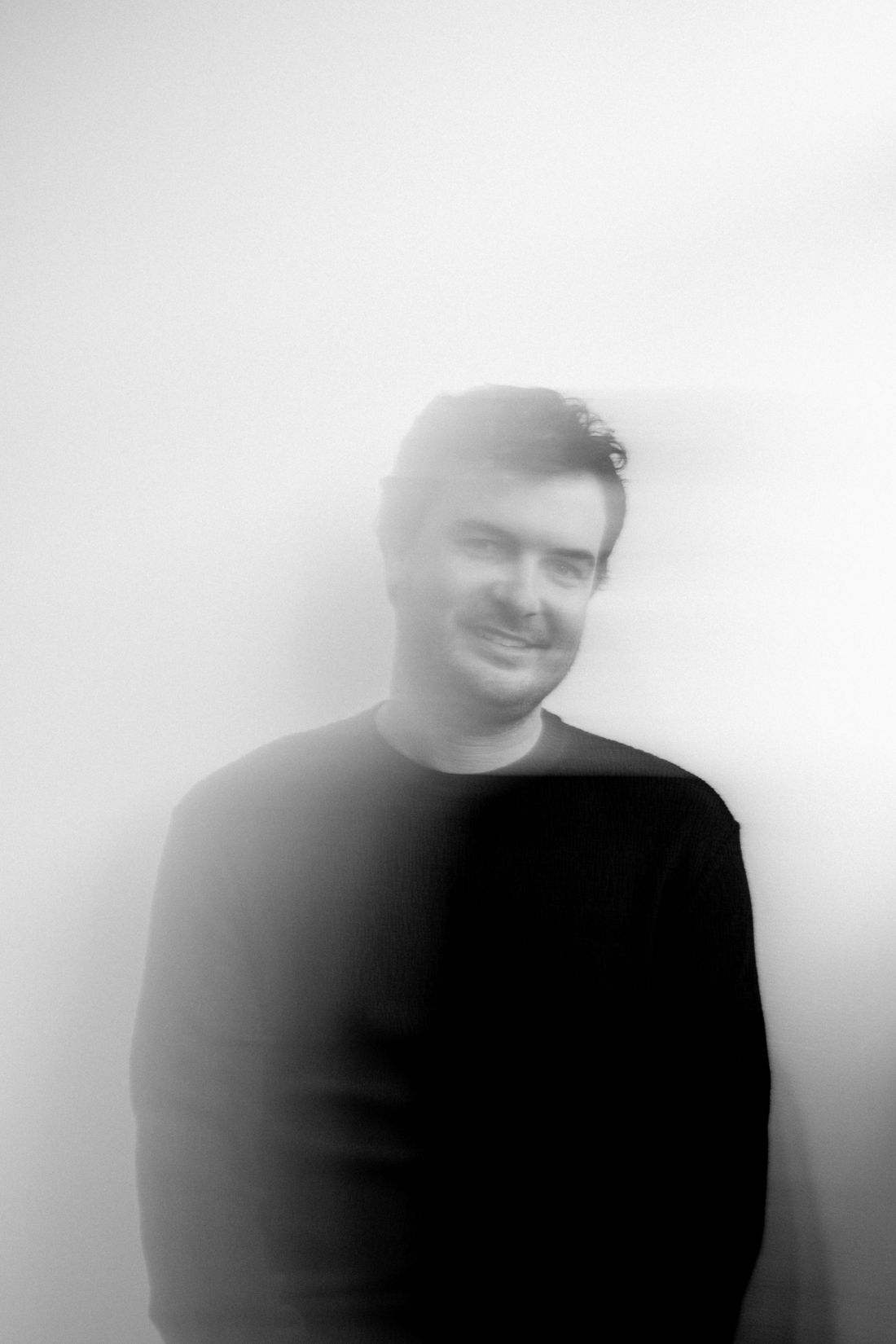Simão sorrindo, imagem desfocada em preto e branco